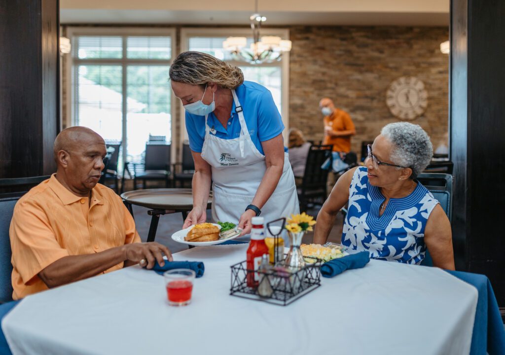 Resident enjoying meal service in dining area.