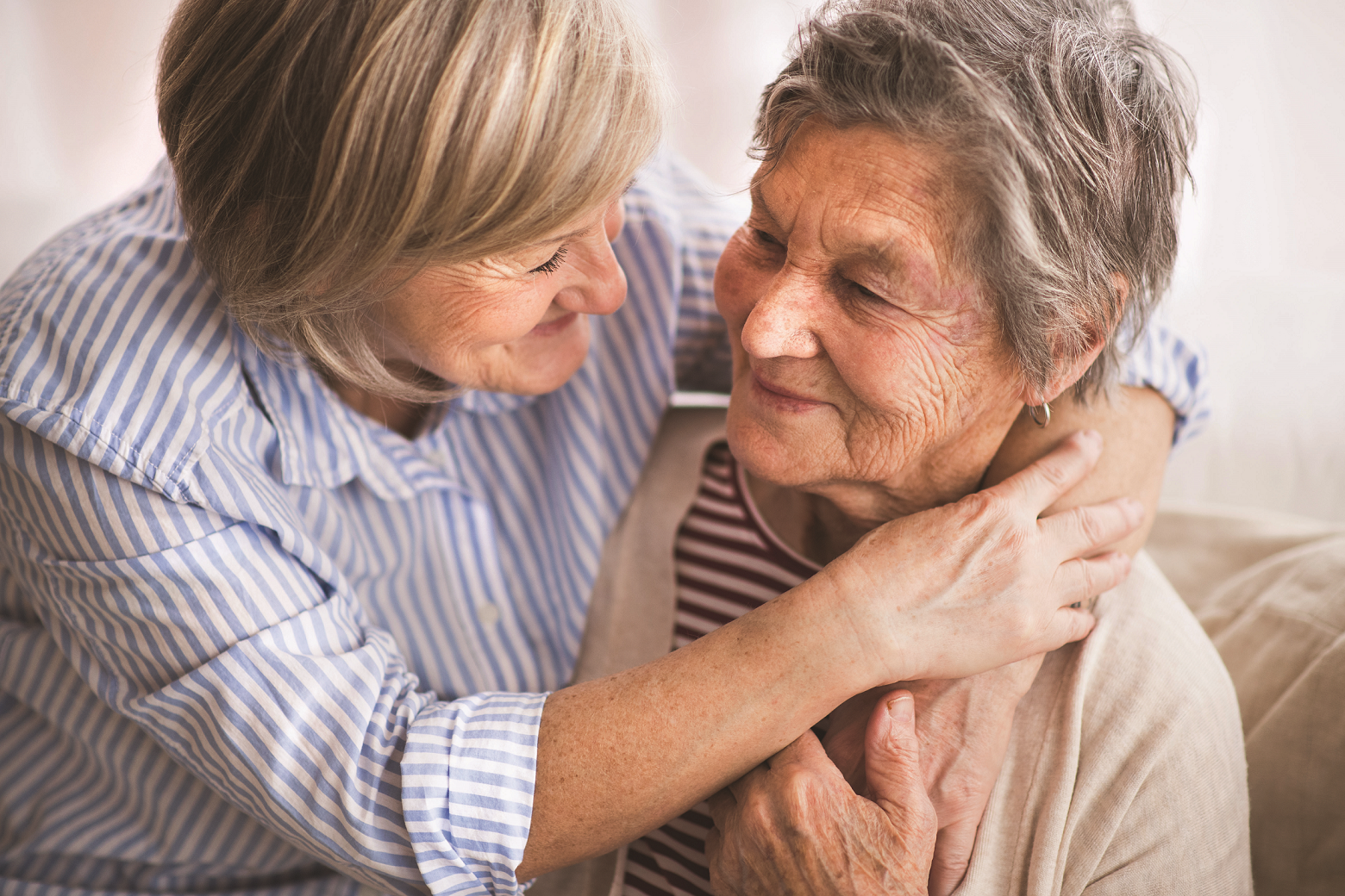 Caregiver and resident sharing a warm moment.