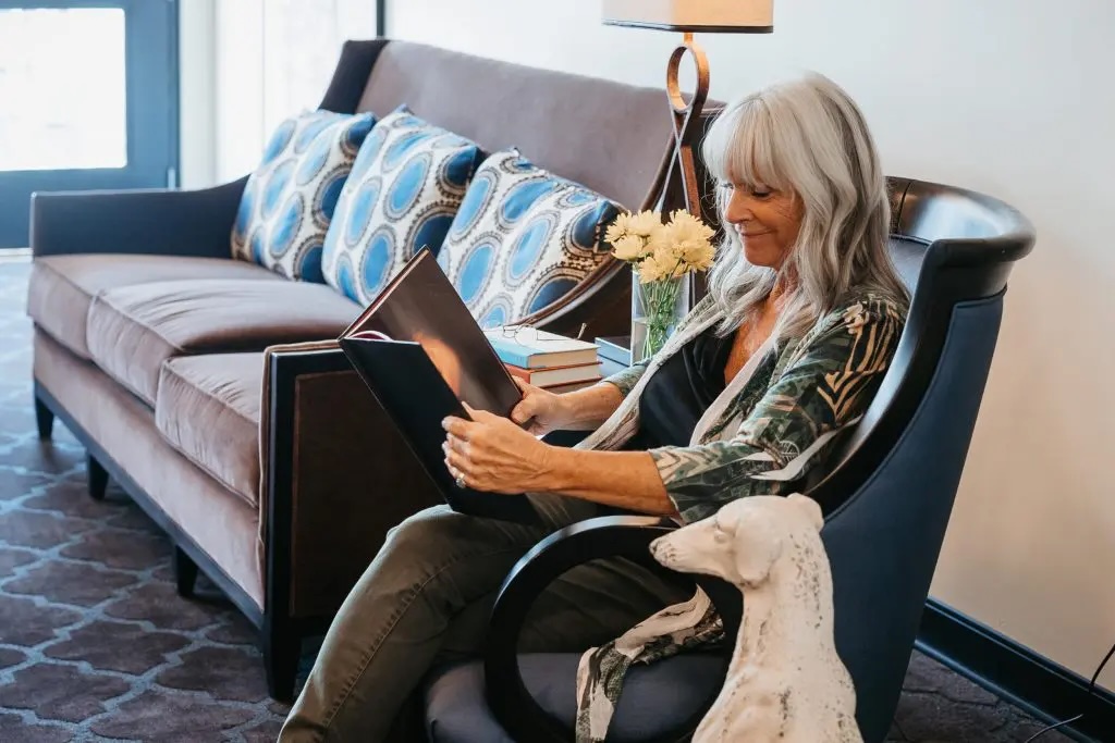 Resident reading in a cozy common area.