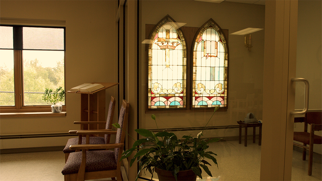Interior space with stained glass windows and seating