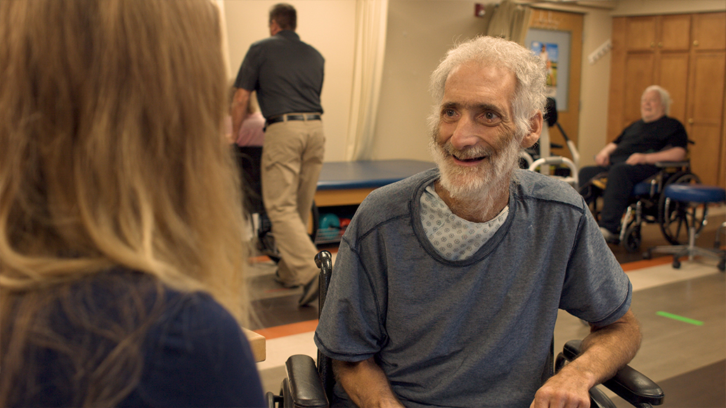 Resident engaging in conversation with staff member