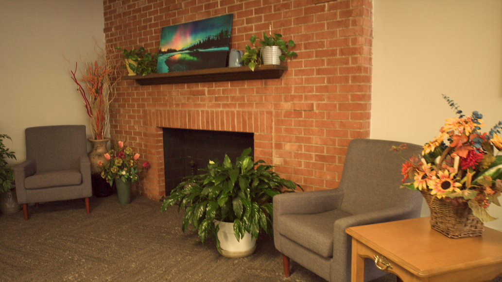 Cozy common area with seating and plants.
