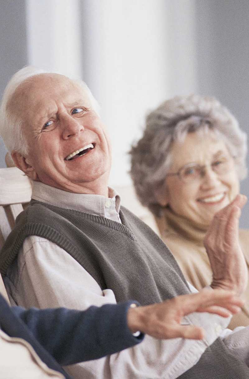 Two seniors smiling and enjoying each other's company.