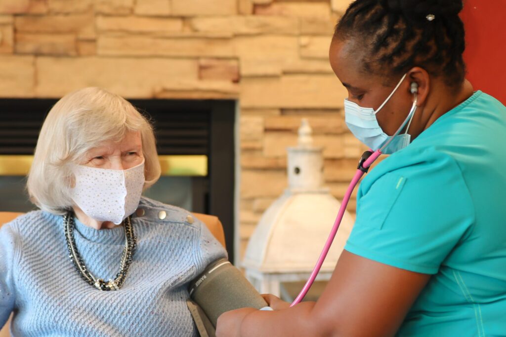 Nurse taking a resident's blood pressure