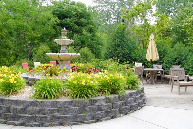 Beautiful outdoor garden with fountain and seating