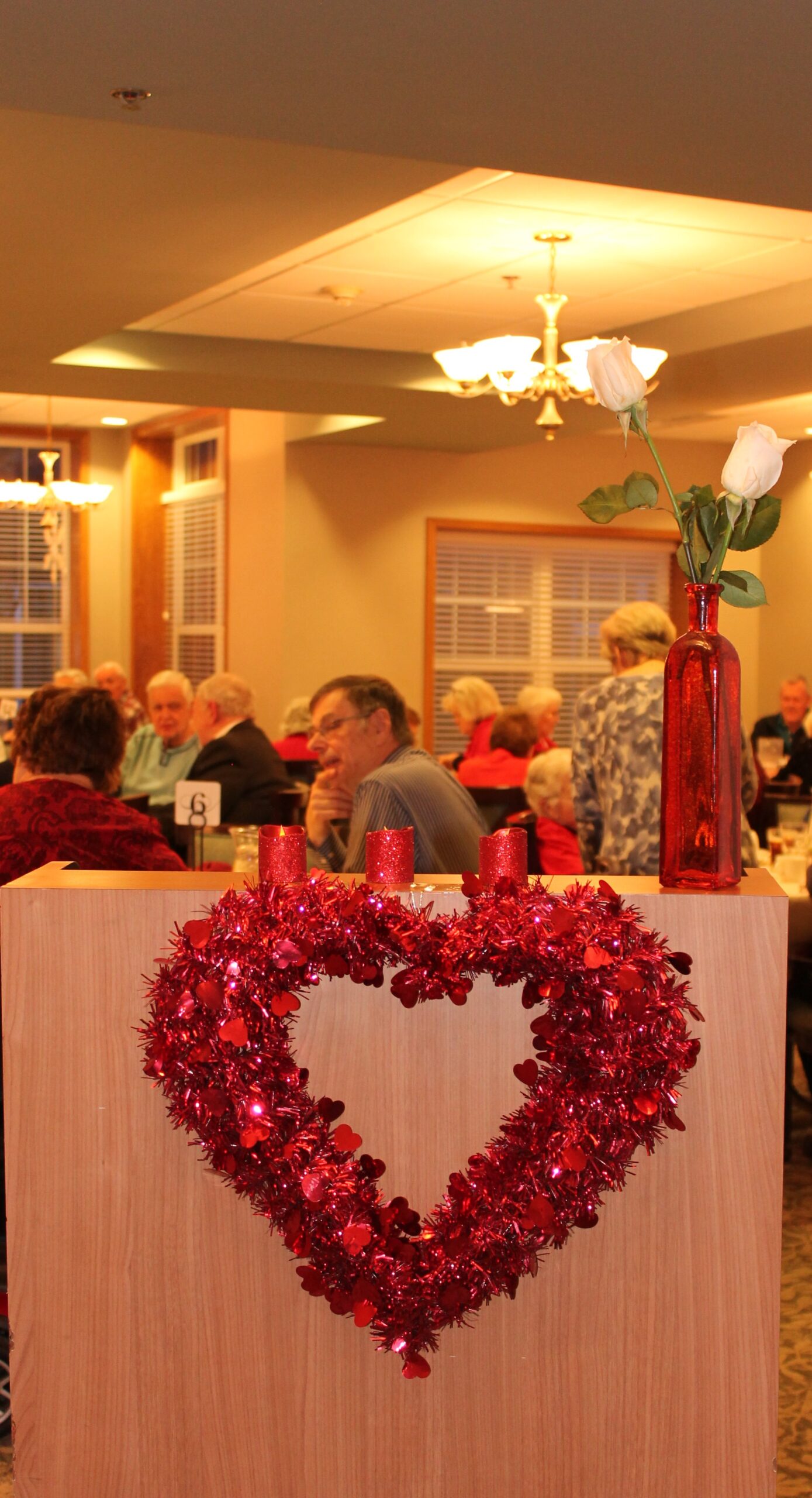 Residents celebrate in a decorated dining area.