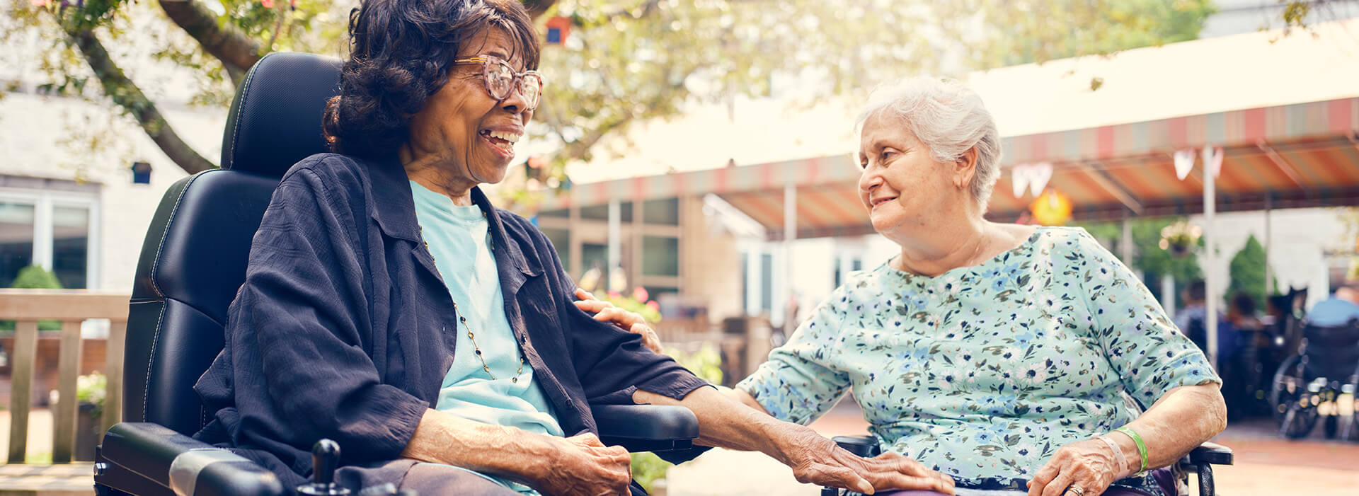 Two residents interacting in an outdoor area.