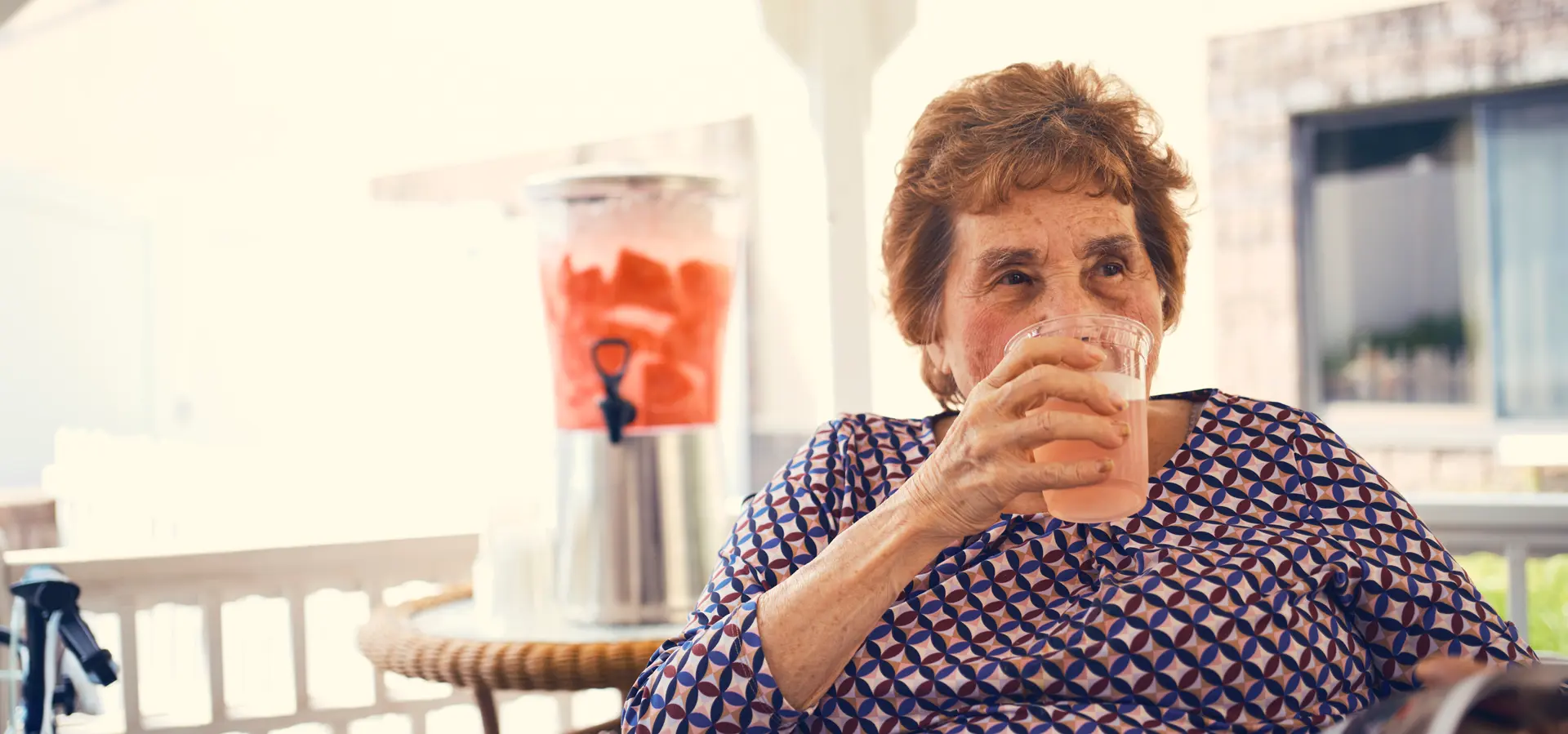 Senior woman enjoying a beverage outdoors