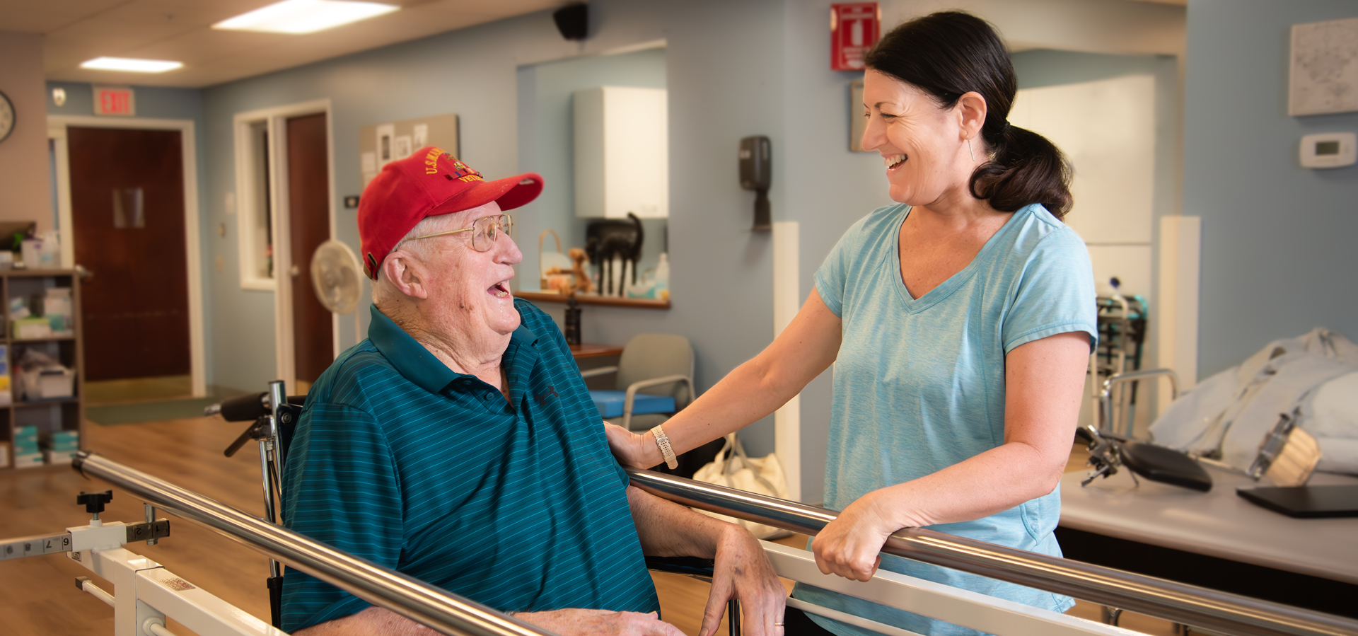 Staff member engaging with a resident in a common area.