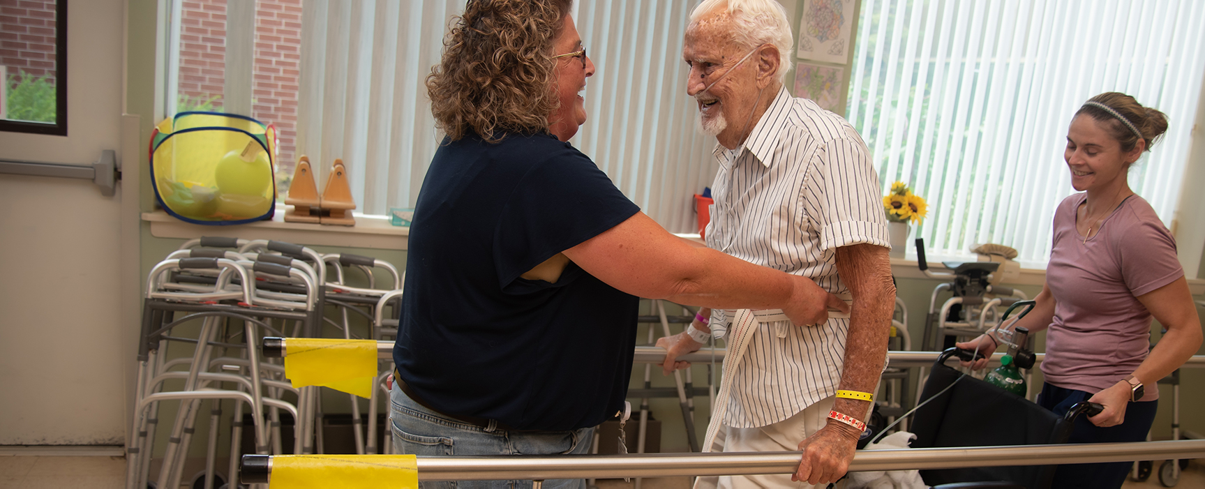 Staff assisting a resident with mobility exercises.