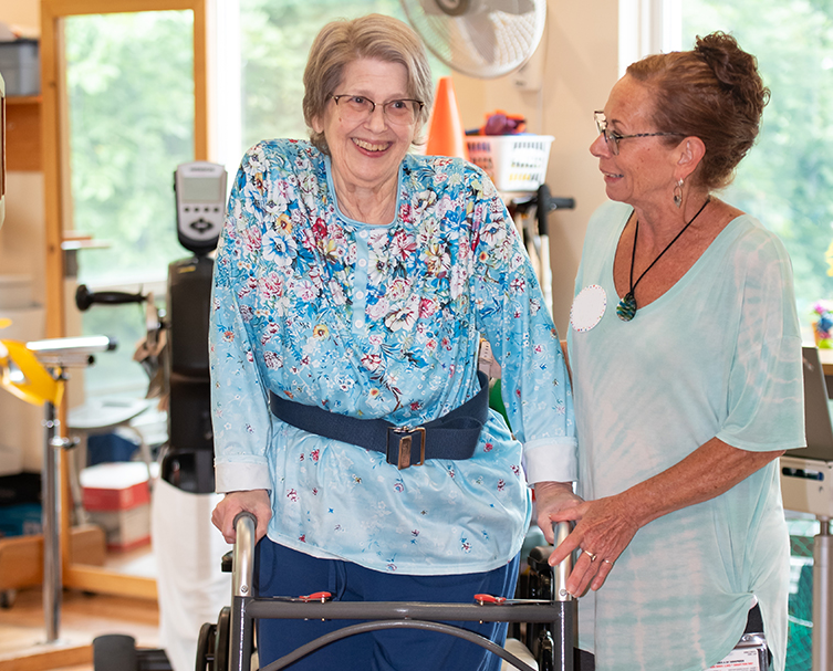 Resident interacting with staff in a common area.