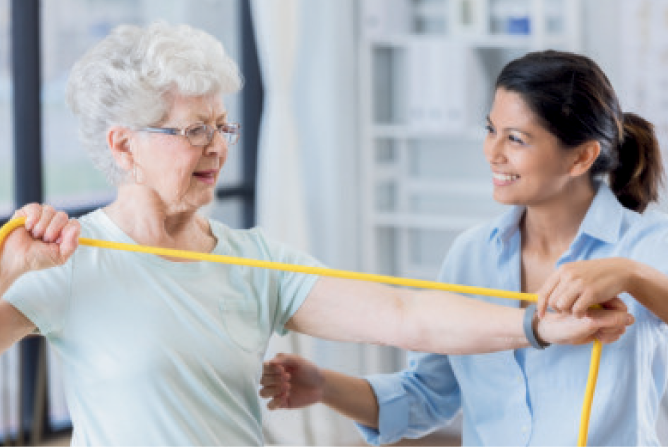Senior woman exercising with staff support