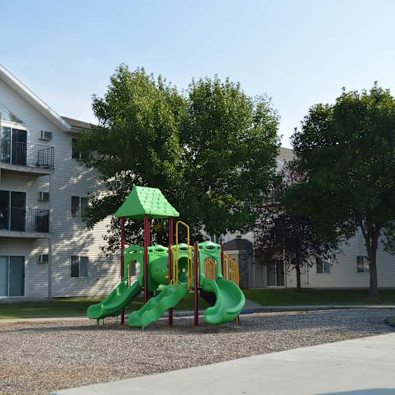Outdoor playground equipment with buildings in the background.