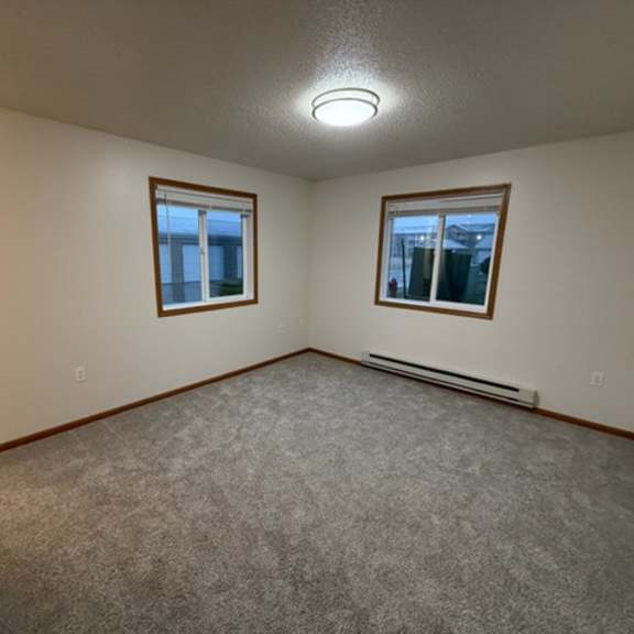 Empty room with carpet and windows.