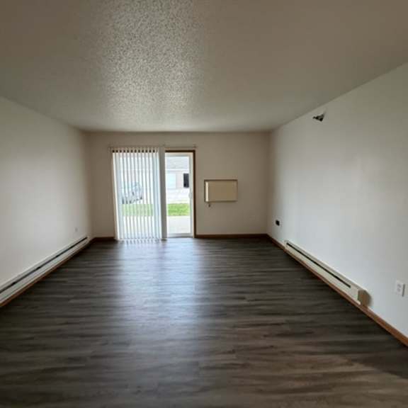 Empty room with sliding door to the outdoors