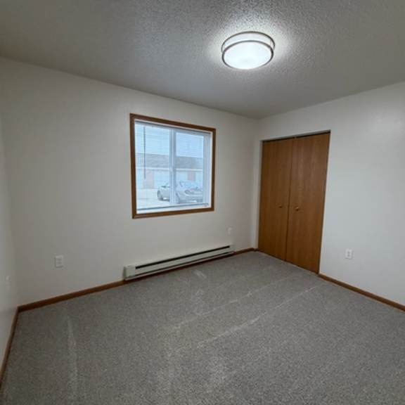 Empty interior room with window and closet