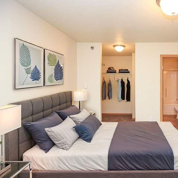 Cozy bedroom with modern decor and lighting.