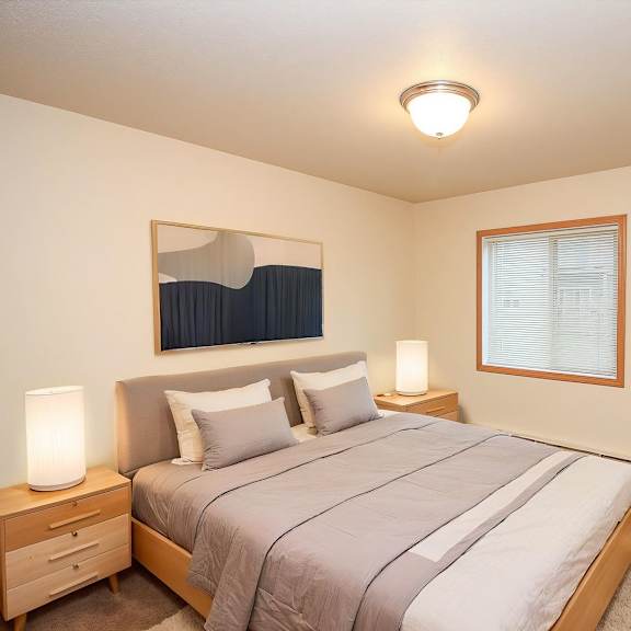 Cozy bedroom with modern decor and natural light.