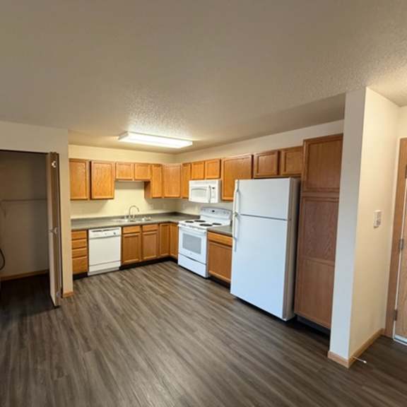 A kitchen area with wooden cabinets and appliances.