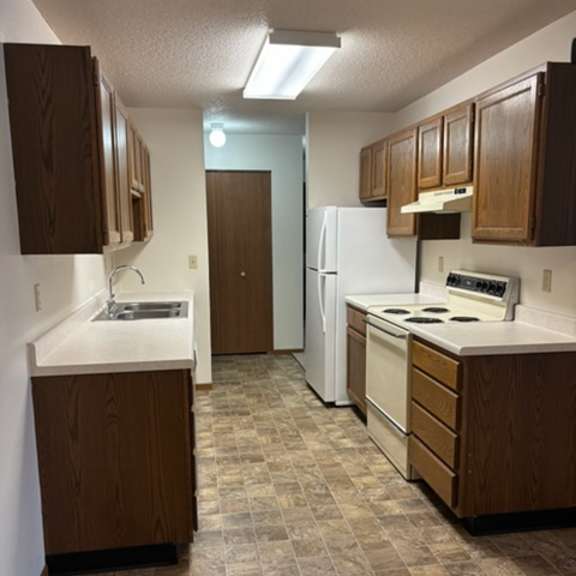 Kitchen area with cabinets and appliances.