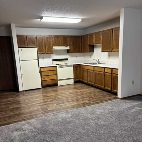 Spacious kitchen area with wooden cabinets