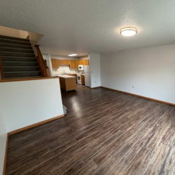 Spacious interior common area with kitchen view.
