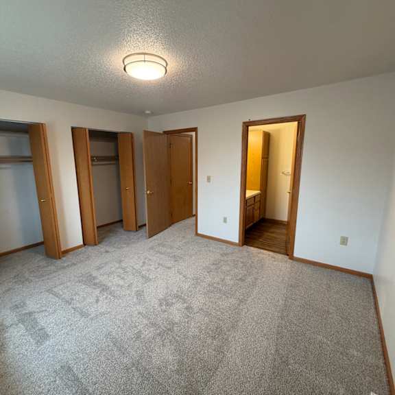 Empty interior room with two closets and bathroom