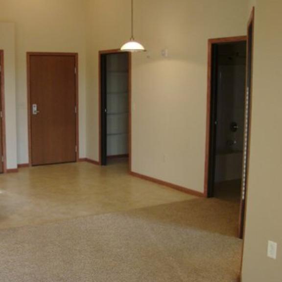 Empty room with beige walls and wooden doors