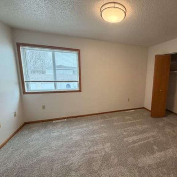 Empty room with window and closet space