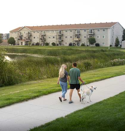 Residents walking a dog along the pathway.
