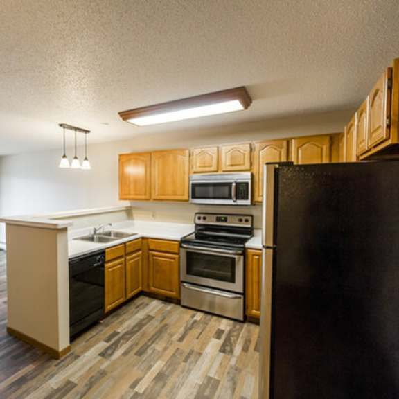 Modern kitchen interior with wood cabinets.