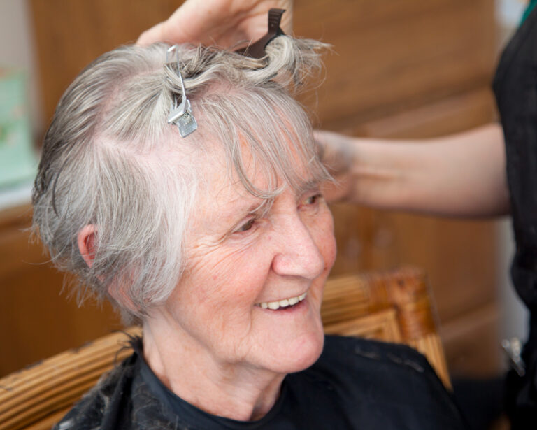 Senior woman enjoying a hair treatment.