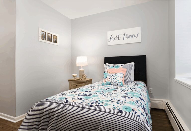 Cozy bedroom with floral bedding.