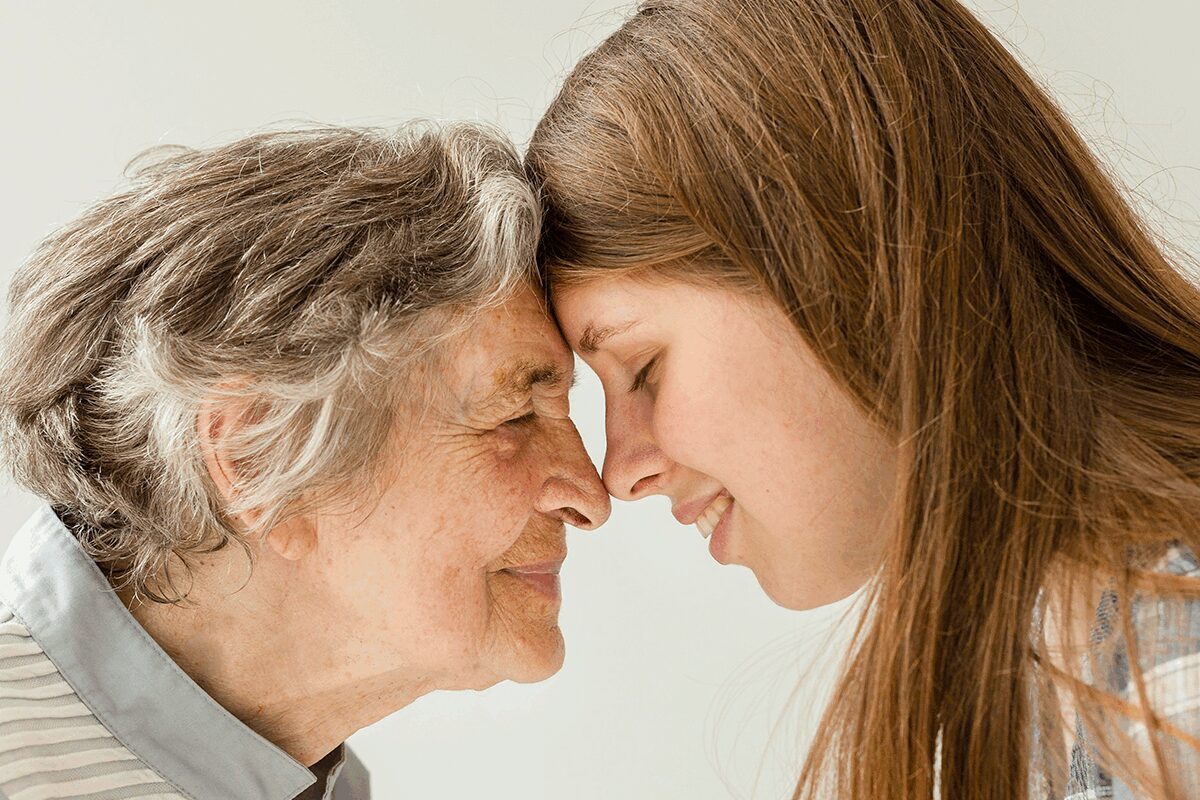 A joyful interaction between an elderly woman and a young girl.