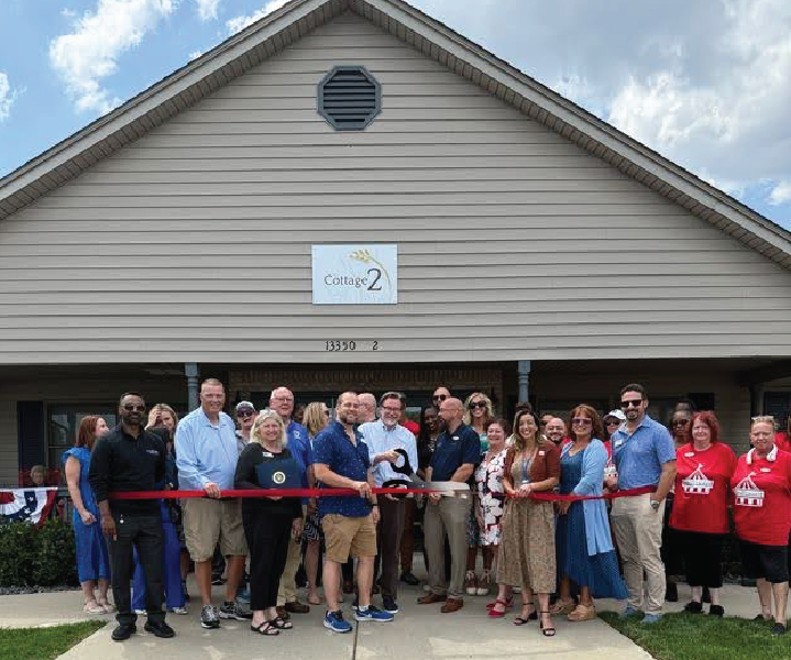 Ribbon-cutting ceremony at facility entrance.