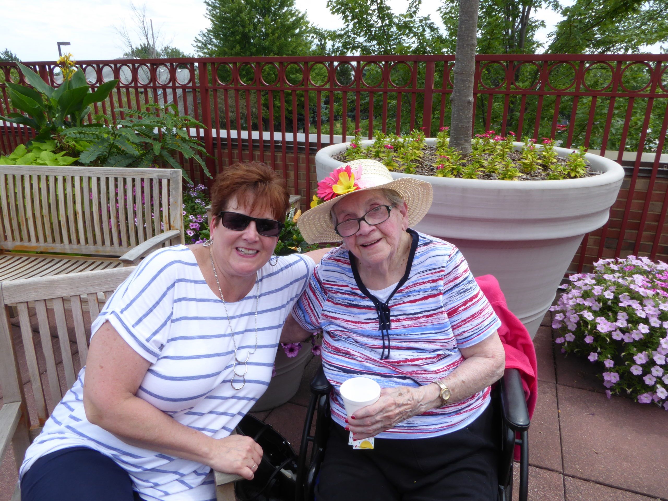 Resident and staff enjoying time outdoors together.