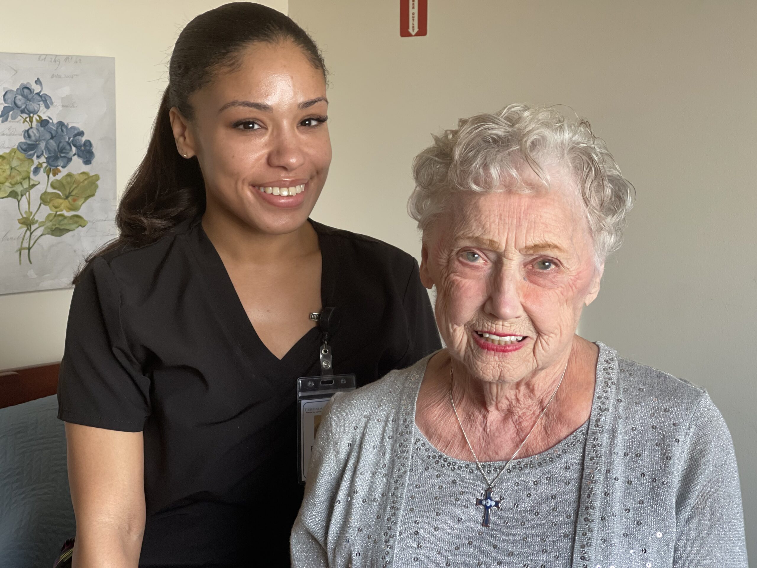 Caregiver and elderly resident smiling together