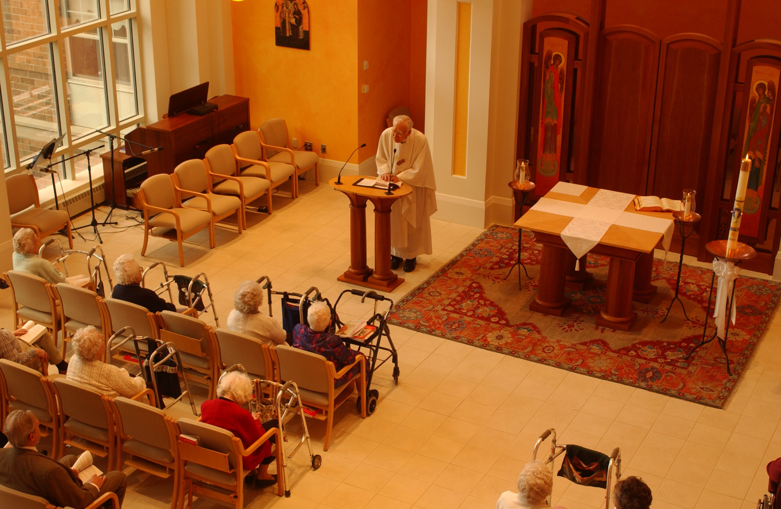 Elderly residents attending a service in a chapel.