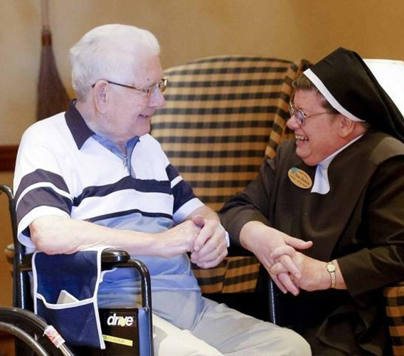 Elderly man chatting with staff member