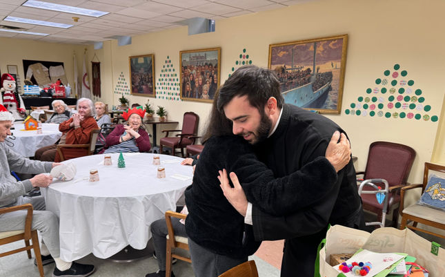 Residents engaging in a warm embrace during an event.