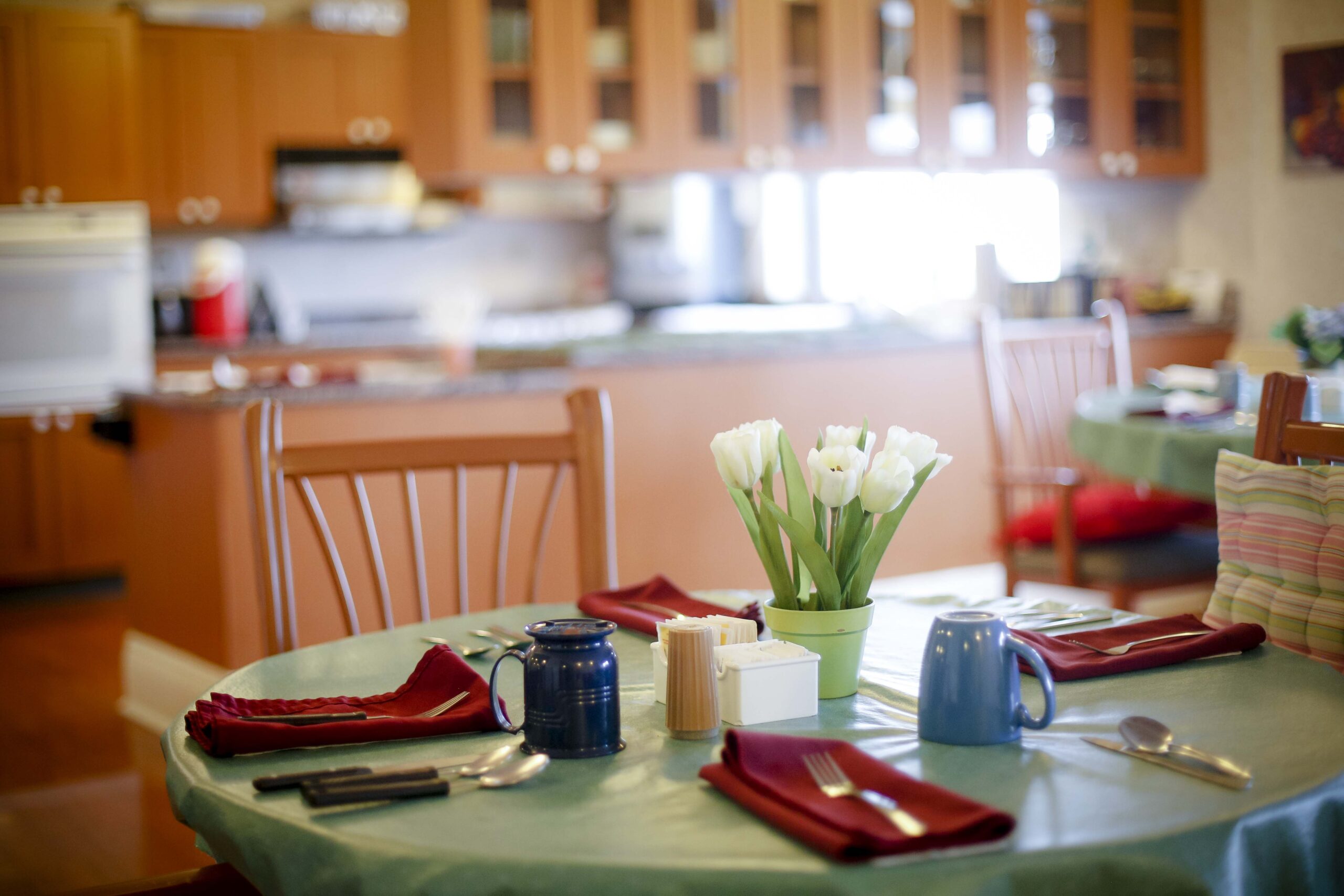Cozy dining area with table settings and flowers