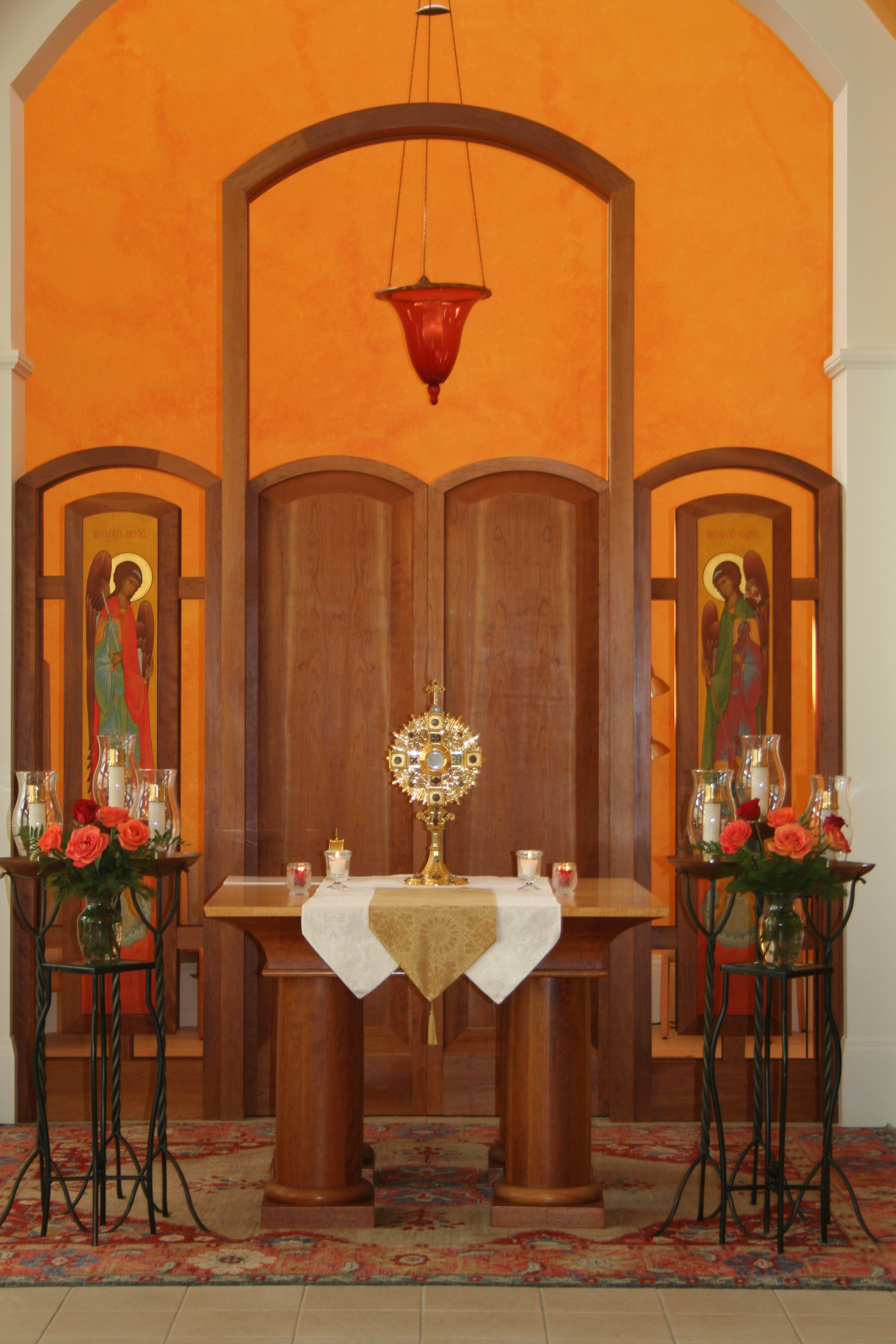 Interior chapel with religious decor and lighting.