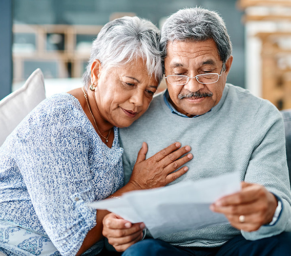 Senior couple reading together in a community space.
