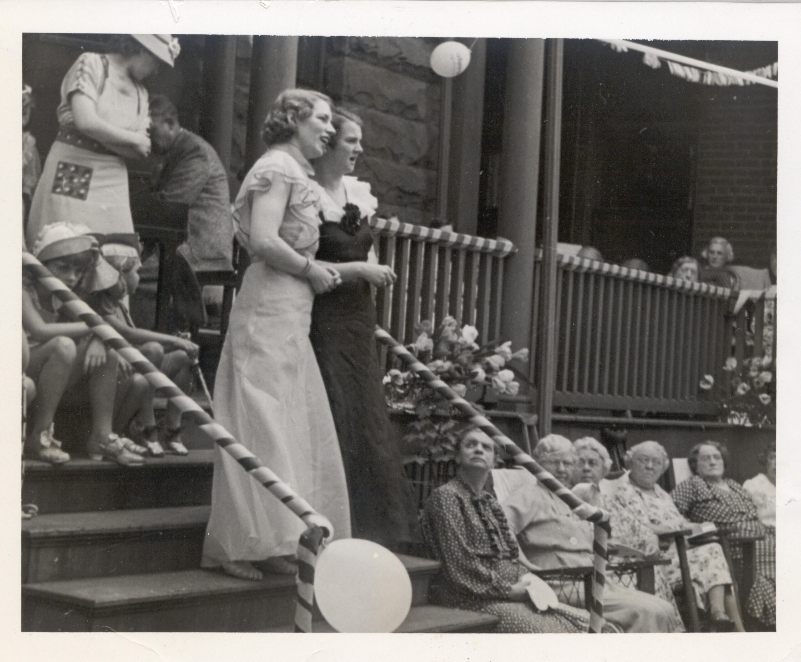 Residents enjoying an outdoor celebration in old-fashioned attire.