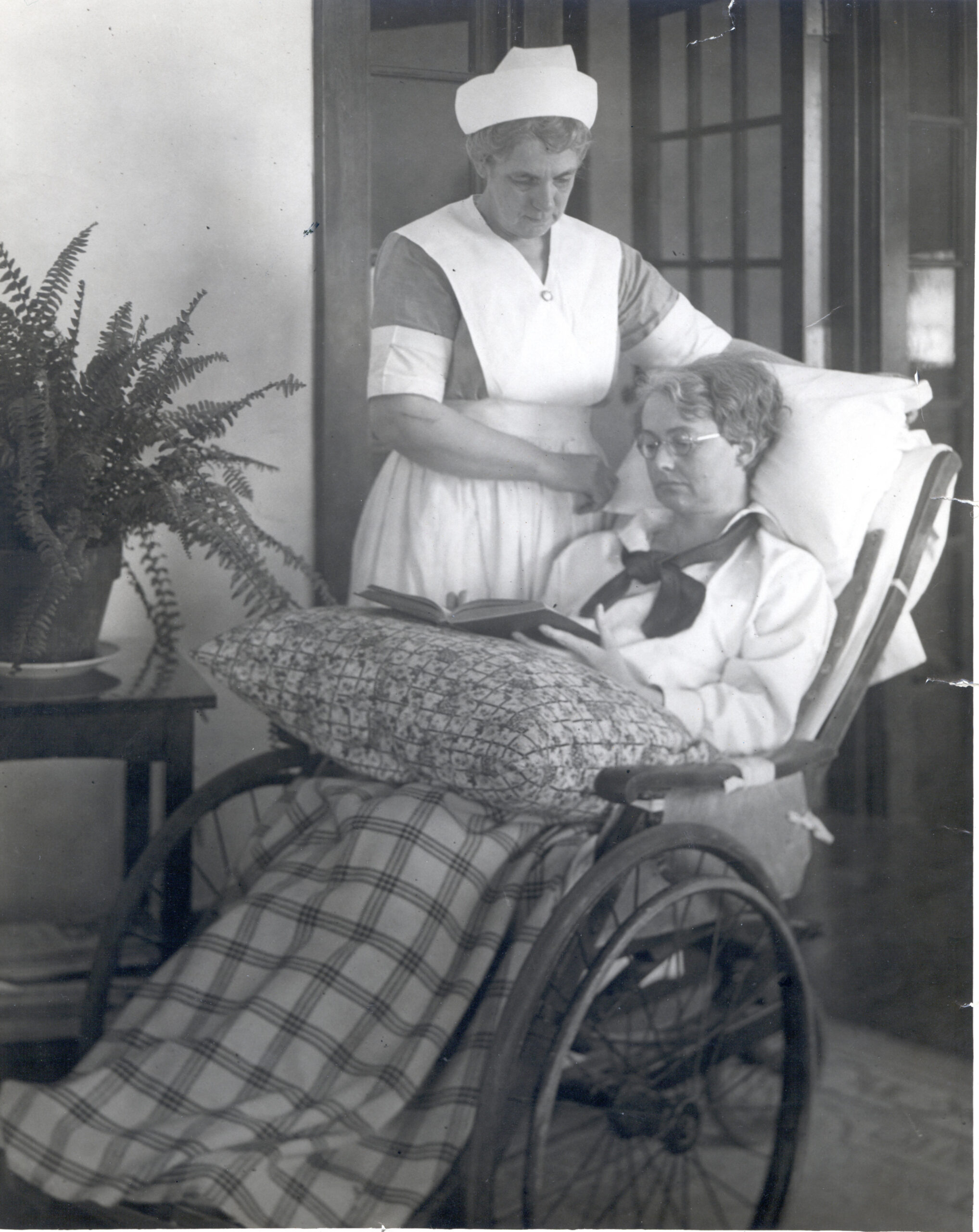 Nurse assisting a resident in a rocking chair