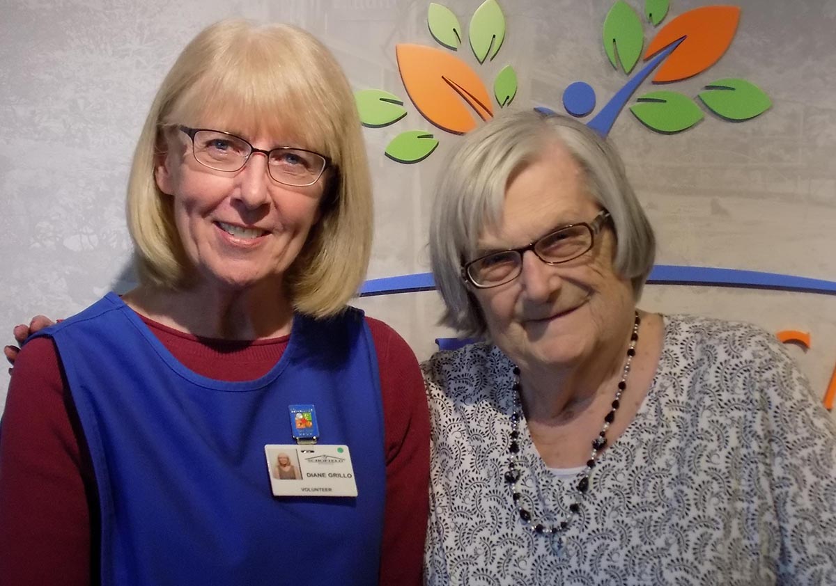 Volunteer with resident in shared space.