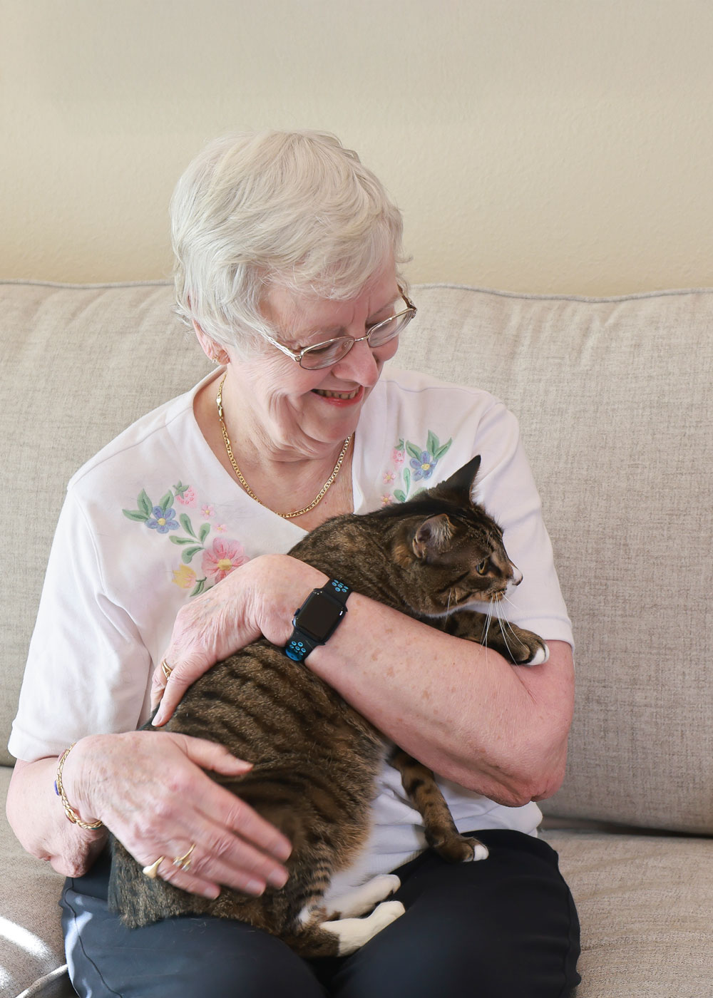 Senior resident cuddling a cat in a cozy setting