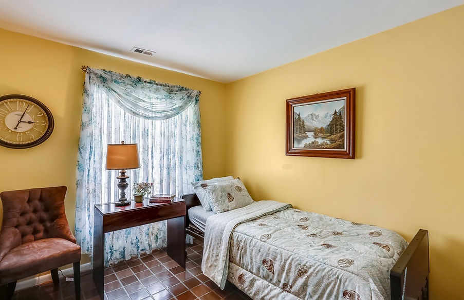 Cozy private resident room with yellow walls and decor