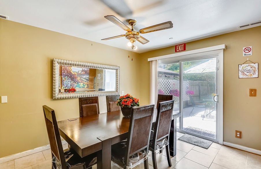 Bright dining area with a large table and outdoor view