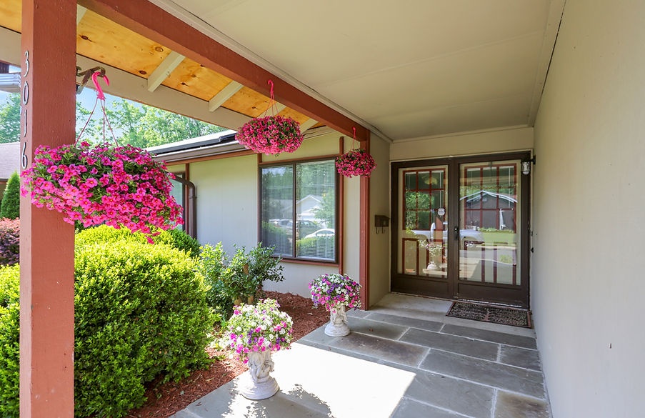 Welcoming entrance with hanging flower baskets